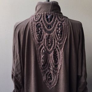 Shrug with elaborate lace back
